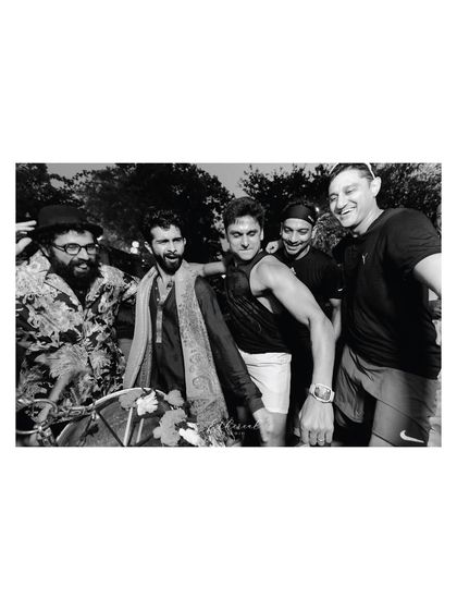 A candid black and white shot of the groom's party, full of energy and excitement. This captures the fun and camaraderie that surrounds the groom on his wedding day.