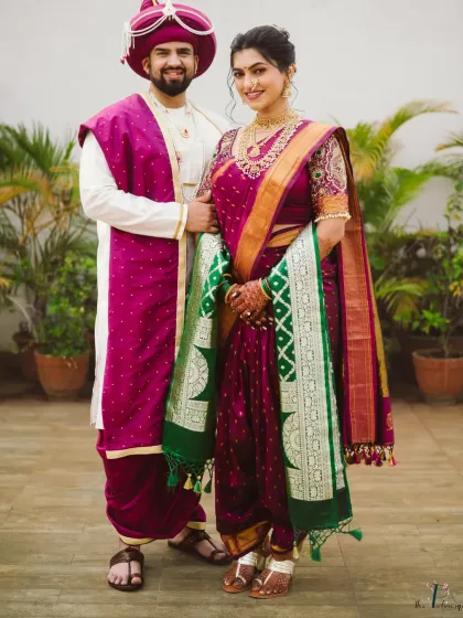 A classic full-length portrait of the bride and groom in their stunning Maharashtrian wedding outfits, a perfect memory of their special day.