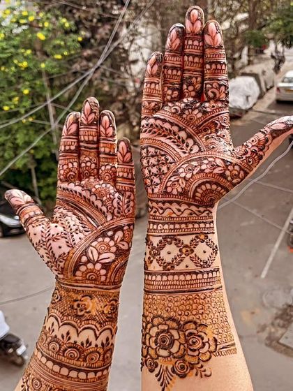 A classic hands-up pose to showcase the full beauty of this traditional Indian mehendi design.