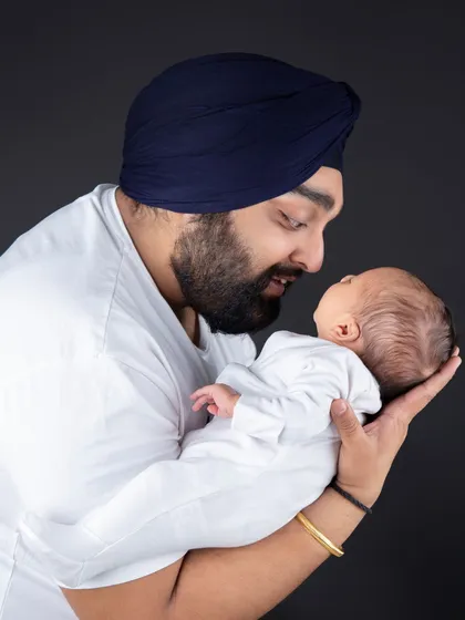 The bond between a father and his newborn is so powerful. This simple, classic portrait focuses on that tender connection.