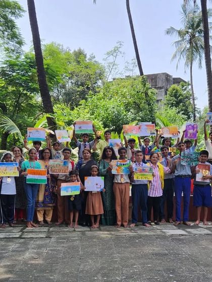 A group photo with all the young artists and organizers at the Lions Club of Juhu art competition. It was a beautiful afternoon celebrating art and community, surrounded by palm trees and happy faces.