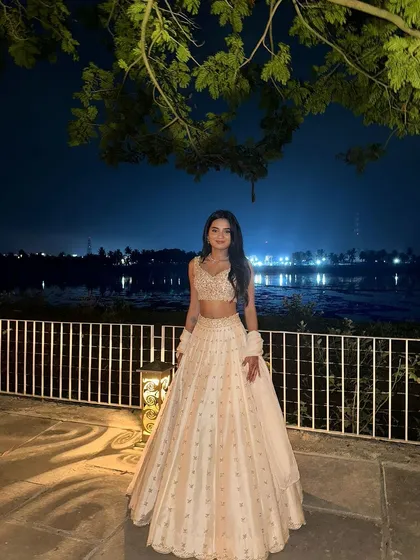 Another lovely shot of the client by the water, her ivory lehenga glowing in the evening light.