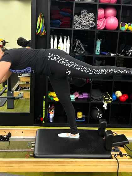 A post-workout stretch is just as important as the workout itself. Here, my client is doing a single-leg elephant stretch on the reformer to lengthen her hamstrings and release her lower back.