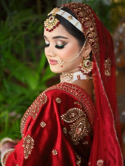 A side profile showcasing the beautiful hair accessory and the soft, glowing makeup.