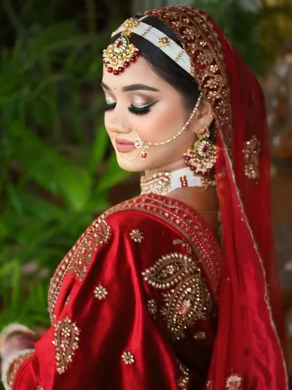 A side profile showcasing the beautiful hair accessory and the soft, glowing makeup.