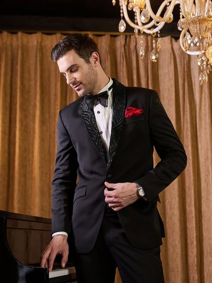 The black tuxedo with patterned lapels, seen here in a moment of quiet sophistication. The fit around the shoulders and waist is precise, a key detail of my custom tailoring process.
