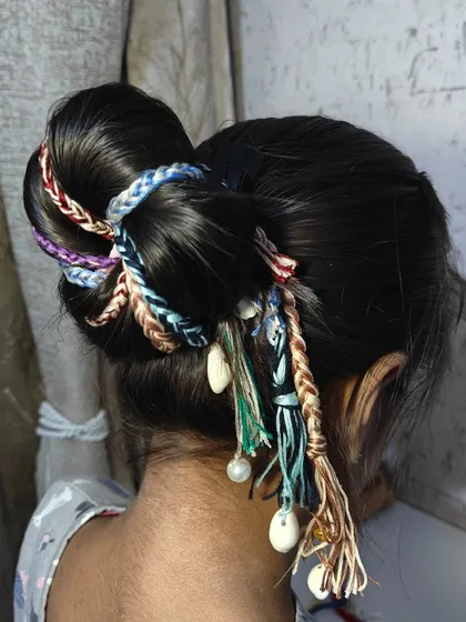 A side view of the boho hair extension bun, showing how the shells and pearls add a delicate, charming detail to the overall look.