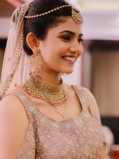 The final look is one of pure joy and elegance. The dewy makeup and glittery eyes make her shine, ready for her special day.