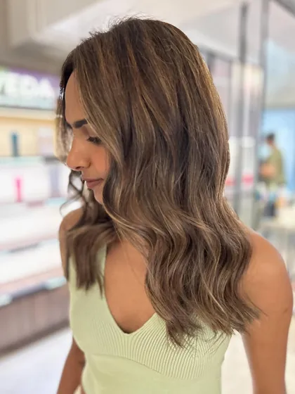 A beautiful three-tone hair color with beige highlights. The face-framing layers add shape and movement to this fresh new look.