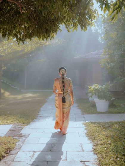 The bride walking along a sun-dappled path, her silhouette creating a beautiful and mysterious image.