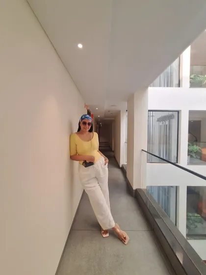 Mentally, I'm still in Goa. This casual look with white linen pants, a yellow top, and a printed bandana is the essence of relaxed vacation style.
