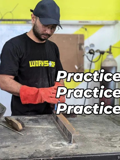 Practice makes perfect. A member wearing safety gloves and a workshop shirt carefully cleans a metal bar before welding. This attention to preparation is a key part of the process that we teach in our metalworking sessions.