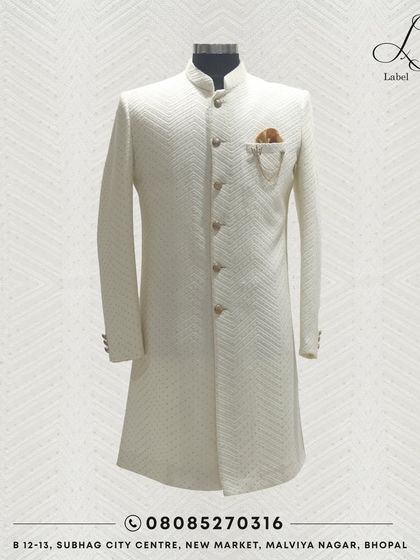 Make a statement with my majestic sherwanis. This classic white piece with a textured weave is a testament to timeless elegance, designed for the modern groom.