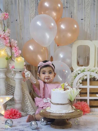 A sweet and gentle cake smash for a little princess. The soft pinks and creams of this boho setup create a beautiful backdrop for her first birthday photos.