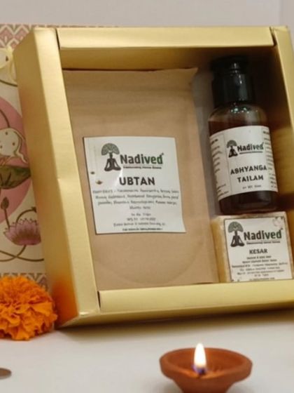 The contents of the Abhyanga Snan gift box, showing the Ubtan pack, Abhyanga Tailam bottle, and Kesar soap bar. Each item is handcrafted for purity and effectiveness.