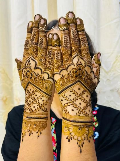 A client showing off her geometric henna design.
