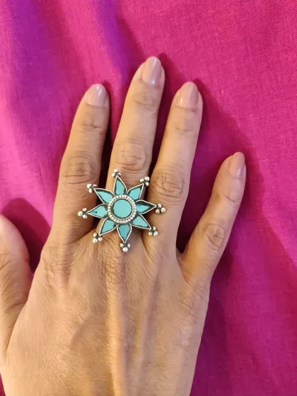A close-up of the stunning turquoise statement ring. A single, bold piece of jewelry like this can be all you need to make an outfit memorable.