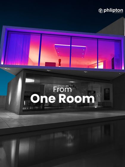 My system can transform a single room with dramatic, colorful lighting, as seen in this modern living space with vibrant purple and red hues.