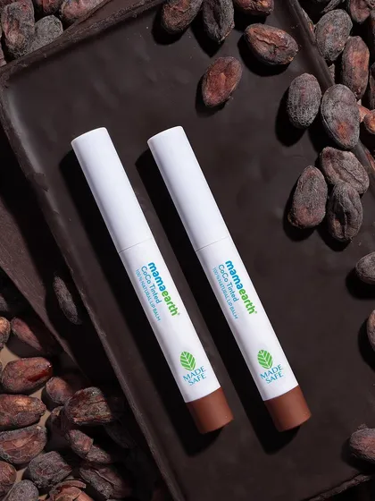 To capture the richness of this cocoa-tinted lip balm, I created a dark, moody scene using a bed of raw cocoa beans. This ingredient-focused styling immediately tells the story of the product's flavor and origin.