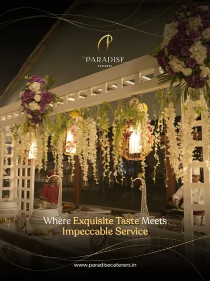 Our catering presentation is designed to be a feast for the senses. This setup features elegant floral arrangements and hanging lanterns over a pristine white buffet counter, showcasing our commitment to combining exquisite taste with impeccable service.