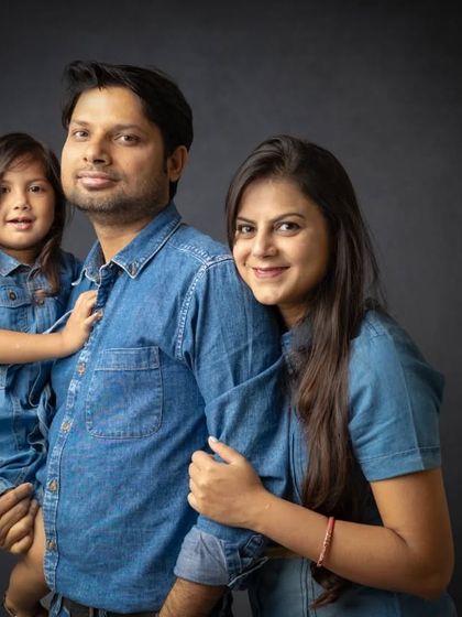 A classic family portrait with coordinated denim outfits. This is a great way to create a look that is both timeless and casually modern.