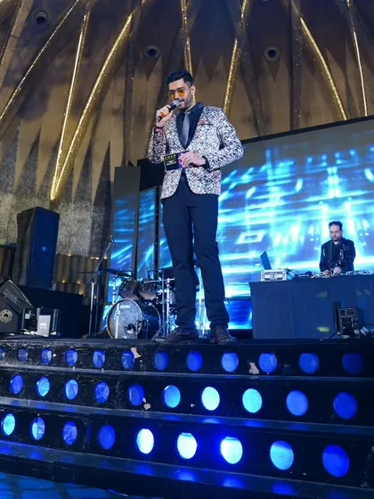 One foot on the ground, one in the air, hosting the wedding with warmth and flair. This shot captures the dynamic energy I bring to the stage to keep the party going.