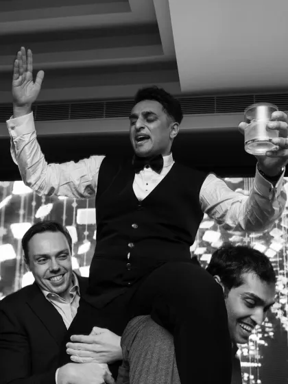 The party is in full swing. A guest being lifted on shoulders is a classic sign of a wild and memorable celebration.
