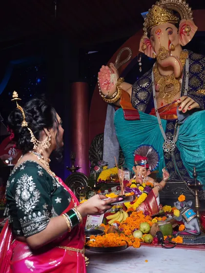 A devotional moment during Ganesh Utsav, with the traditional Marathi look adding to the festive spirit.