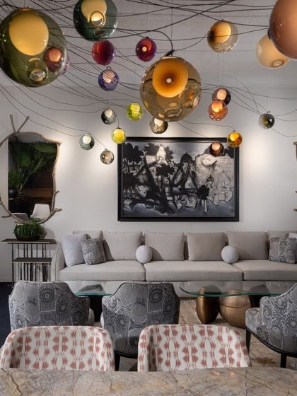 A view of the lounge seating under the magnificent Bocci light installation. The combination of our bespoke furniture, rich textiles, and dramatic lighting created an atmosphere of sophisticated warmth.