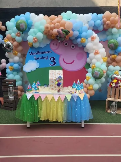 The main cake table setup for a Peppa Pig third birthday party.