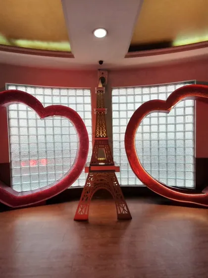 A romantic Paris-themed photo point featuring two large light-up hearts and a model of the Eiffel Tower. This setup is perfect for adding a touch of love and elegance to any event.