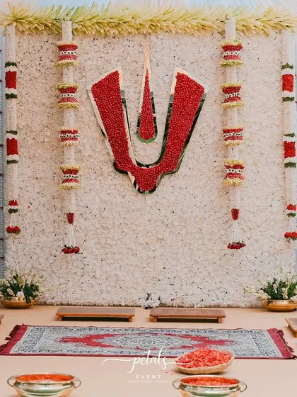 Honoring heritage is central to my work. For this Telugu Nalugu ceremony, I designed a sacred backdrop featuring a dense wall of white chrysanthemums with a bold red Balaji Nama, creating a divine and auspicious focal point for the rituals.