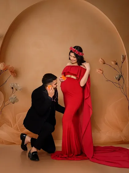 A fun and creative maternity shot where the partner playfully uses a tin can phone on the baby bump. This adds a touch of humor and personality to the session, showing that maternity photos can be both beautiful and lighthearted.