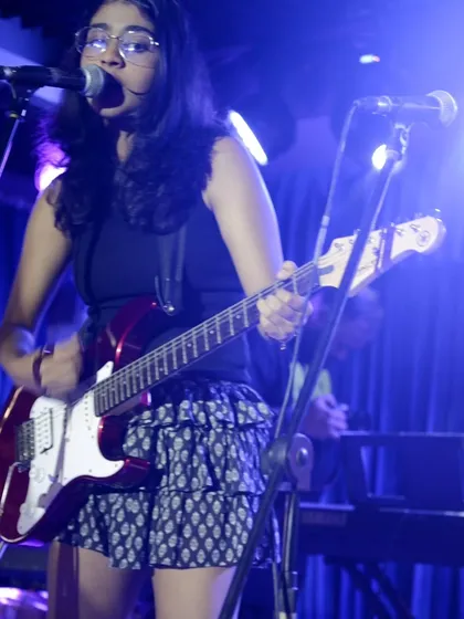 The ultimate goal for many of our students is performing live. This shot captures one of our talented guitarists on stage at our annual showcase, confidently playing for a live audience. We create these opportunities to celebrate their hard work.