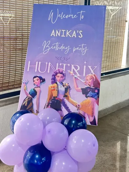 A stylish welcome sign for a K-Pop 'Huntrix' themed birthday party. The design matches the main backdrop, ensuring a consistent and immersive theme throughout the event space.