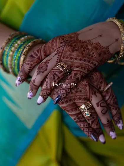 A candid shot of the stained hands, adorned with rings, showcasing the beauty of the finished art.