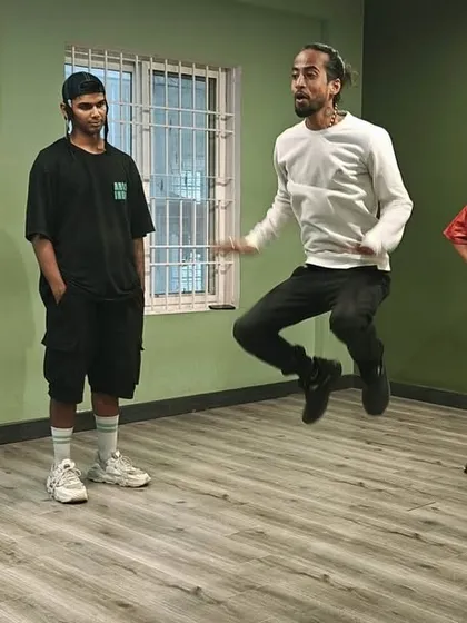 An instructor demonstrates a move while students watch. Our classes are hands-on, with a focus on clear instruction and practice.