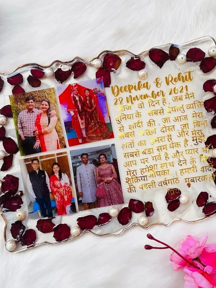 A memory frame filled with love. This 9x12 inch piece features a collage of photos and a heartfelt message, all surrounded by preserved rose petals and pearls.