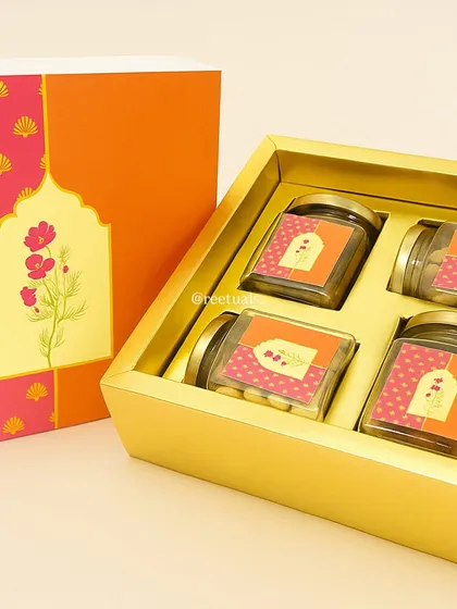 This bright and cheerful dry fruit box is a classic Diwali gift. I designed the packaging with vibrant pink and orange floral motifs, and the box contains four glass jars ready to be filled with your choice of nuts and treats.