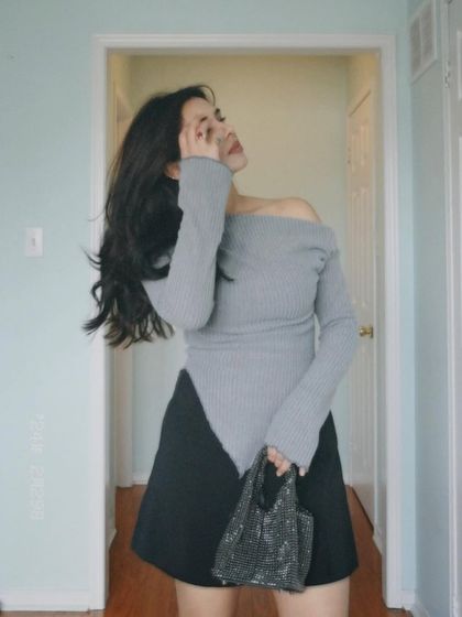 An expressive, artistic pose in the grey top.