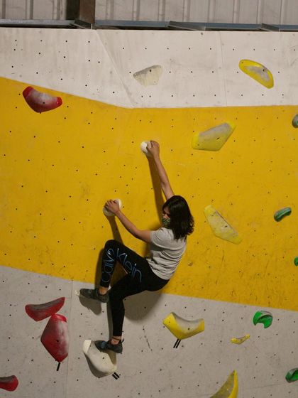 It's not just about power, but also precision. This climber demonstrates excellent technique while navigating a challenging route.
