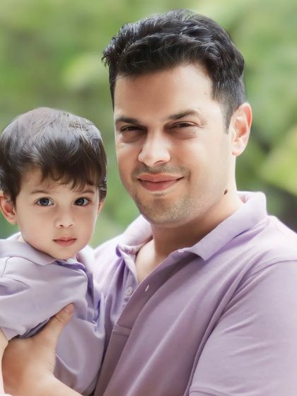 The feeling of safety in a father's arms. This tender father and son portrait is a simple, powerful expression of family love and connection.