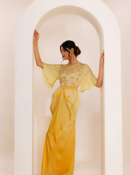 Another pose from the yellow dress shoot, showing the full silhouette. This look is perfect for a festive brunch or a day event.