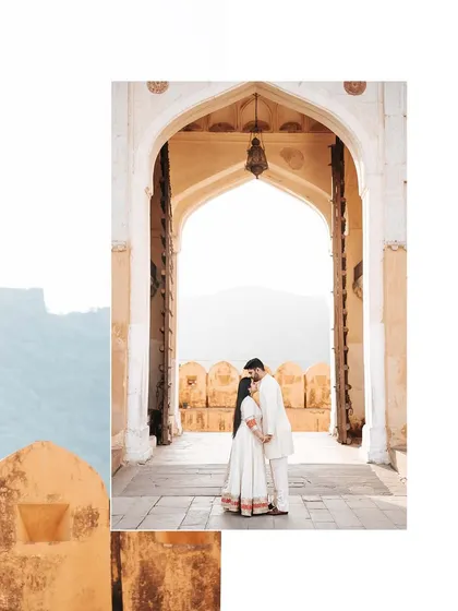 An artistically framed shot of the couple in an archway at Amer Fort, using layers to create depth and visual interest.