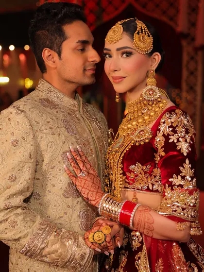 A beautiful portrait of the couple. Her makeup features defined eyes and a warm, radiant complexion that perfectly complements her groom.