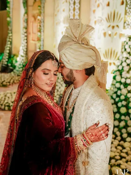A romantic portrait of the bride and groom, where her elegant updo is visible.