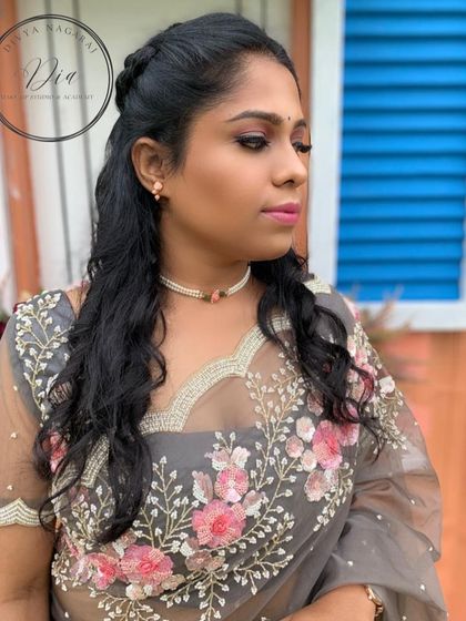 A soft and romantic look for a pre-wedding shoot. I used shades of pink on her eyes and lips to complement the floral embroidery on her grey saree, keeping the look fresh and pretty.