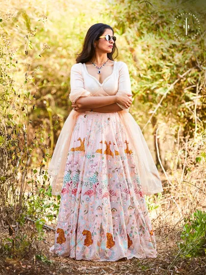For a daytime wedding or an outdoor event, this light pink printed lehenga is a dream. The unique animal and floral motifs add a whimsical touch, while the silhouette remains elegant and chic.