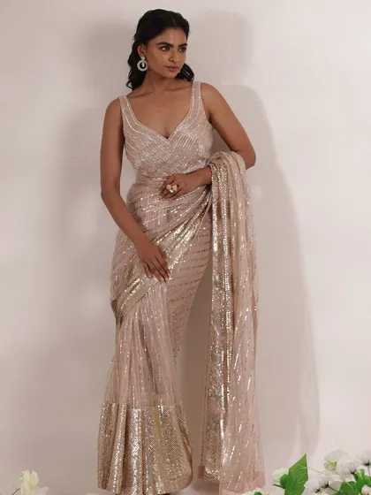 Another angle of the beautiful sequined saree, showing how it drapes and flows. The matching embellished blouse completes this glamorous ensemble, making it ideal for a wedding guest who wants to make a statement.