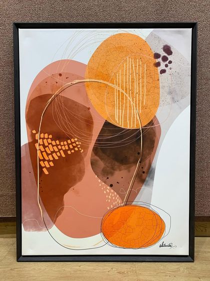 This minimalist abstract artwork is enhanced by a veneer wood floater frame. The dark frame provides a sharp contrast to the light background of the canvas, making the orange and brown shapes pop.